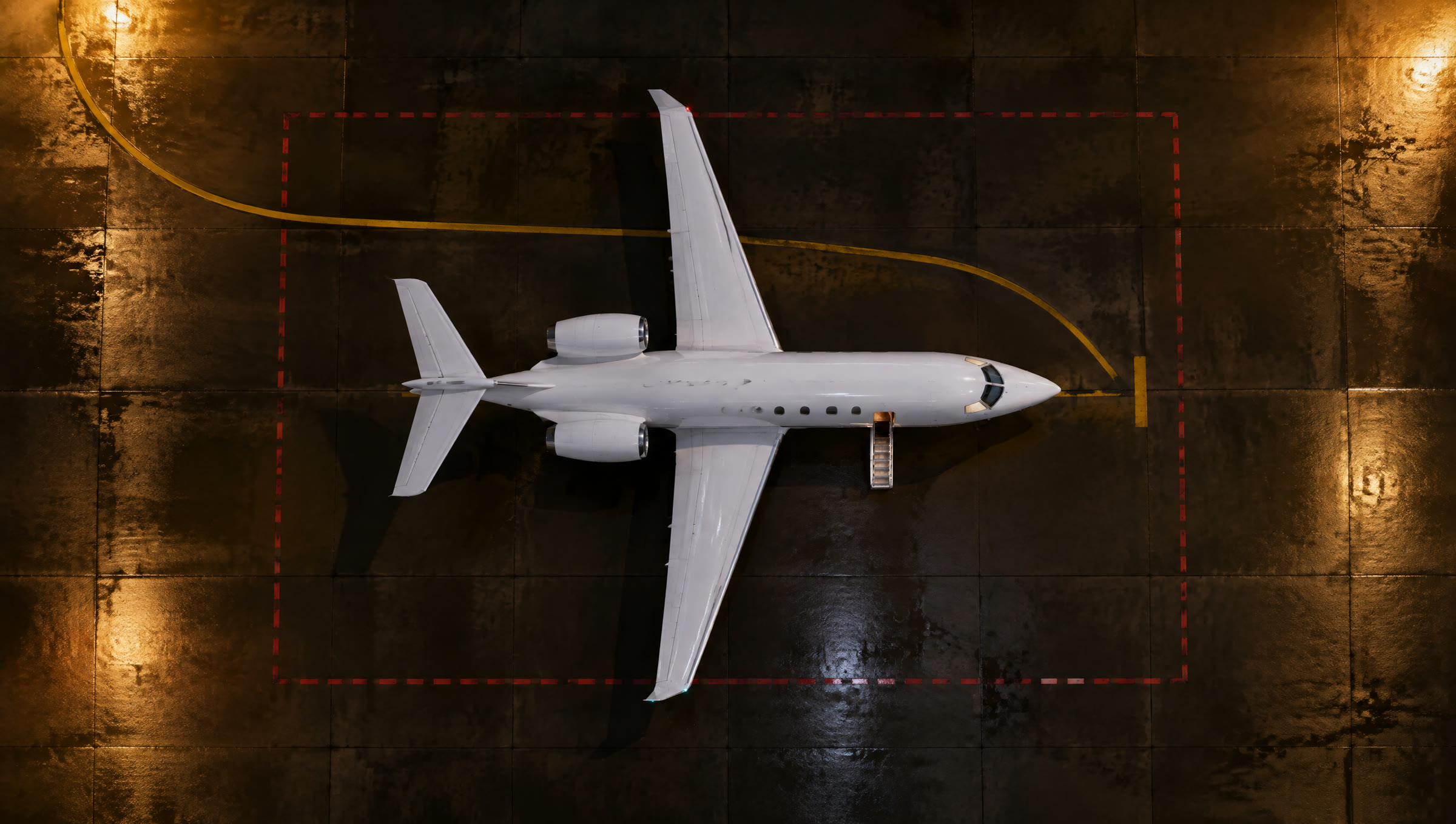Night aerial view of an aircraft stand with a business jet parked in the centre